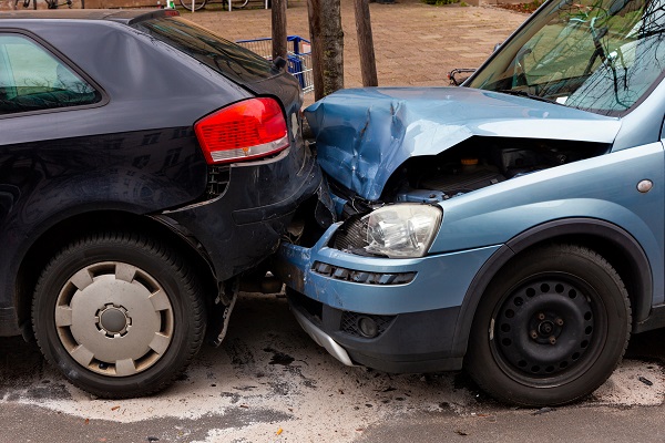 Two heavily damaged cars following a rear-end collision