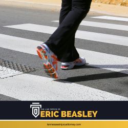 A pedestrian in Nashville, TN crossing the street in a crosswalk